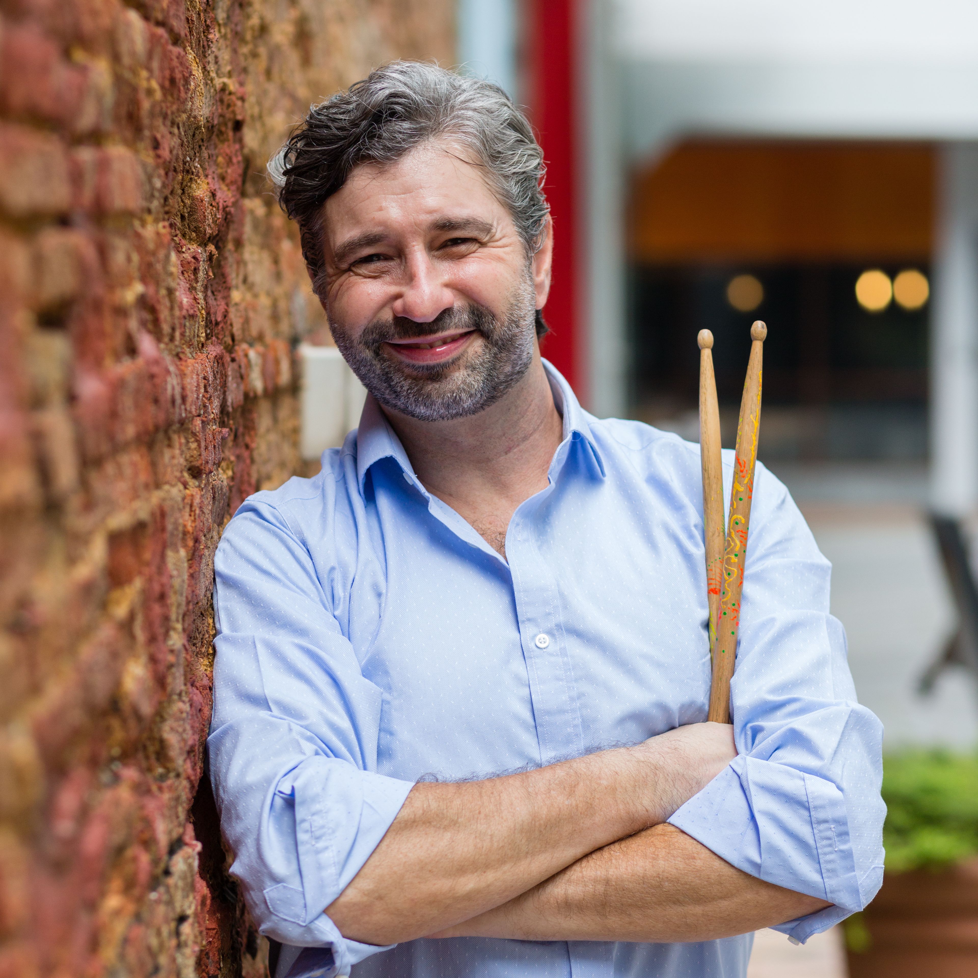 Grant 'Upbeat' Bosnick (with sticks on wall) (square).jpg